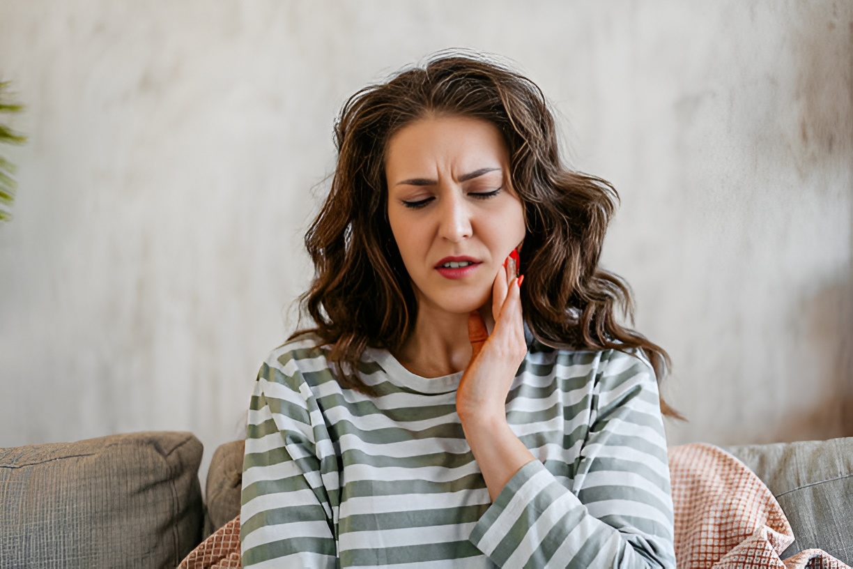 distressed woman touching her jaw